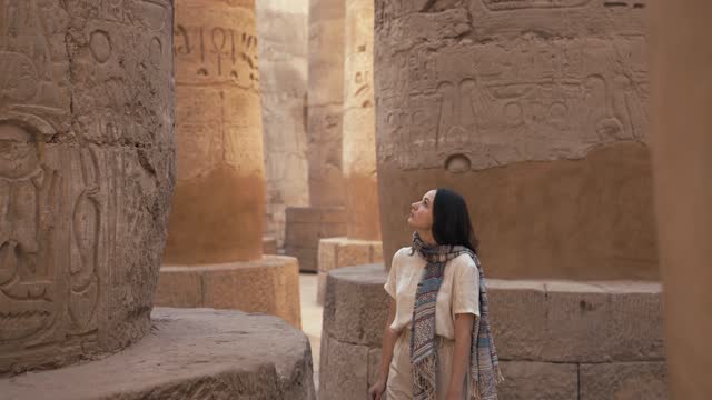 Woman walking in the ancient Egyptian temple in Luxor