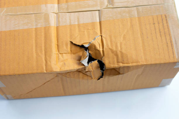 istock Damaged cardboard box with hole 1304256951