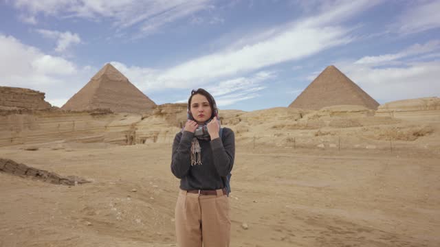 Portrait of woman in hijab on the background go Giza pyramids