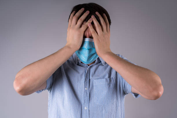 istock Headache and migraine, man with coronavirus symptoms on gray background 1304259316