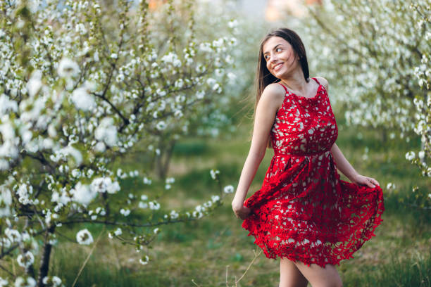 istock Young woman among blooming trees 1304260125