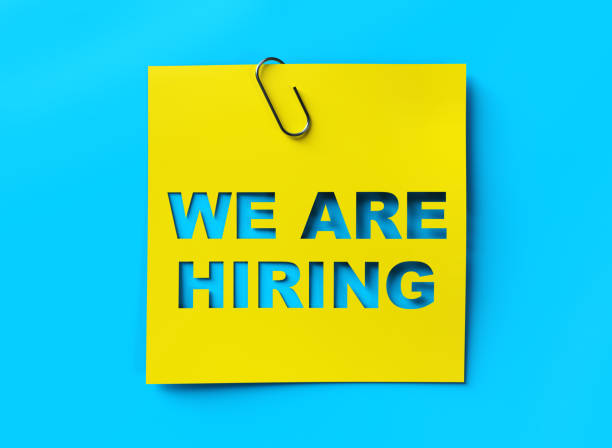 "We are hiring" yellow banner on blue textured background "We are hiring" yellow banner on blue textured background help wanted sign photos stock pictures, royalty-free photos & images