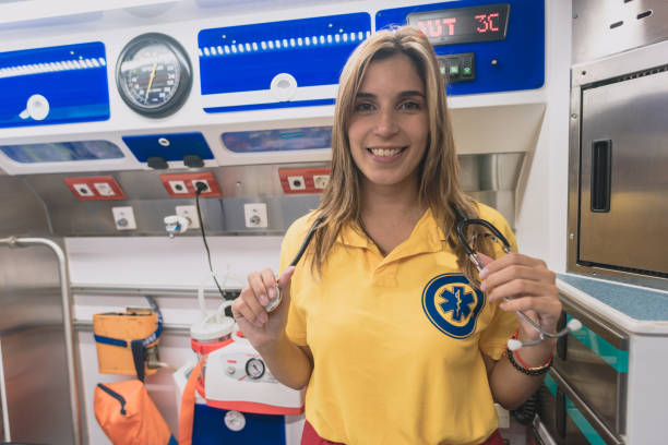 young sanitary woman prepares with her tools in an ambulance stock photo