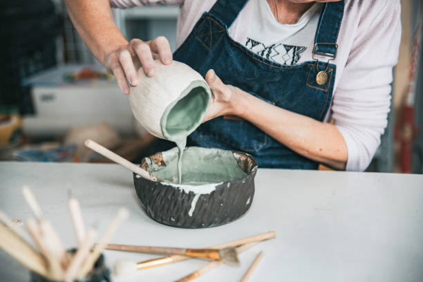 young artisan woman working with her hand a piece of ceramic focus on hand stock photo