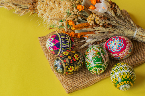 Easter eggs, palm tree on a yellow background, with space for text