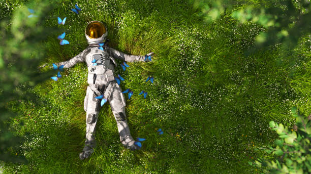 Astronaut lying in the meadow An astronaut in full suit surrounded by monarch butterflies is resting in a lush green garden explorer photos stock pictures, royalty-free photos & images