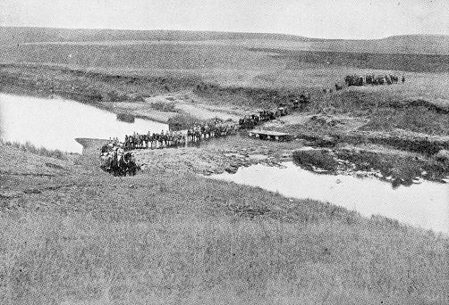 The British military crossing the Klip River in Kwazulu-Natal, South Africa. Vintage photo etching circa 19th century.