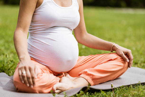 istock Pregnant woman doing yoga 1304265564