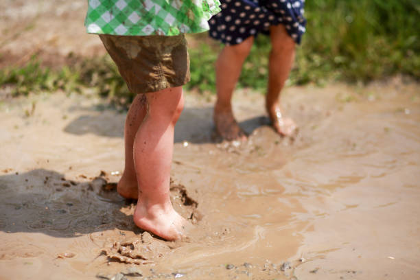 istock Two little girls in mud puddles 1304265917