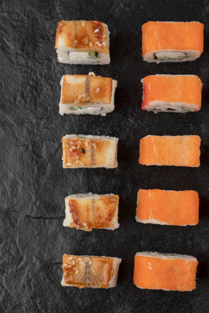istock Dragon and philadelphia sushi rolls placed on black surface 1304266948