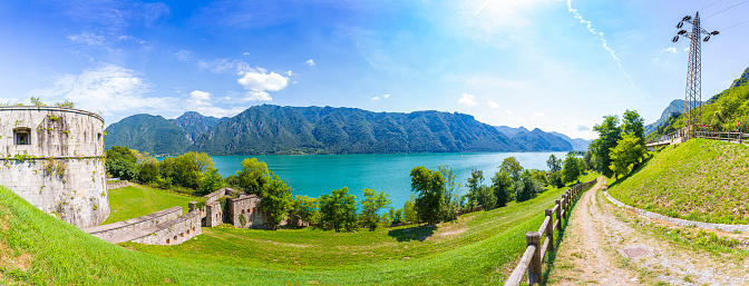 Panoramic view at the beautiful landscape of lake Idro Rocca d'Anfo Italy, ruins of a old bunker. Clouded summer day, colorful scene high resolution..