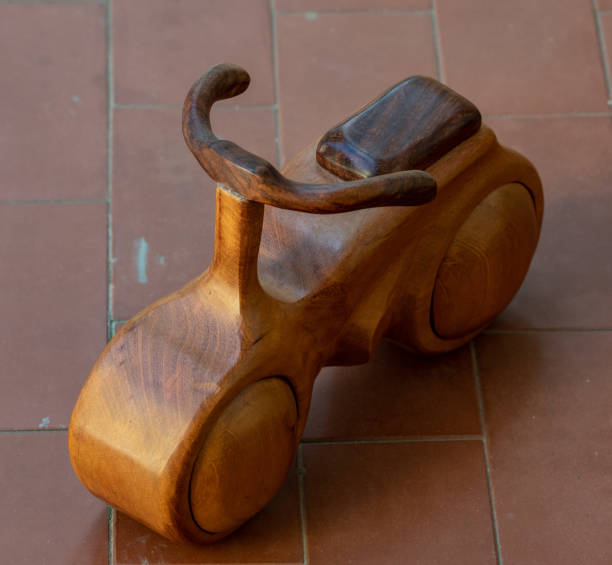 istock Wooden motorcycle with dark saddle and handlebar. 1304270941