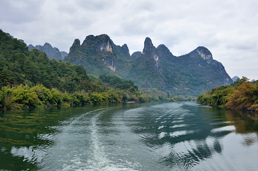 China - East Asia,Guilin,Yangshuo county,Yangdi township,\nXingping town.\nGuilin karst has been included in the world heritage list.\nKarst landform scenery along the Li River,From Guilin to Yangshuo,It is 63 km in length.\nIt's the most beautiful landscape waterway has about 15 km,It goes from Yangdi to Xingping.\nHere the Li River snakes through a fairy-tale landscape of conical limestone peaks,its smooth waters exquisitely mirroring the magical.\nLijiang River and its tributaries,the shuttle in the \nShiShanfeng forest,mountains and water and hold,very beautiful.\nBeautiful Lijiang River,is the world's largest and most beautiful karst landscape scenic resort.\nGuilin is the country a shining pearl in the mountains and rivers, unique and beautiful Lijiang River karst making it a world-famous tourist destination.\nLarge numbers of tourists visit the Li river by yachts every year.