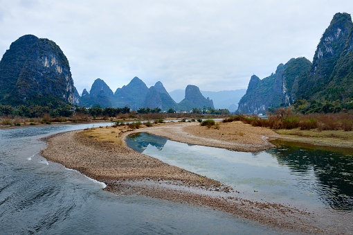 China - East Asia,Guilin,Yangshuo county,Yangdi township,\nXingping town.\nGuilin karst has been included in the world heritage list.\nKarst landform scenery along the Li River,From Guilin to Yangshuo,It is 63 km in length.\nIt's the most beautiful landscape waterway has about 15 km,It goes from Yangdi to Xingping.\nHere the Li River snakes through a fairy-tale landscape of conical limestone peaks,its smooth waters exquisitely mirroring the magical.\nLijiang River and its tributaries,the shuttle in the \nShiShanfeng forest,mountains and water and hold,very beautiful.\nBeautiful Lijiang River,is the world's largest and most beautiful karst landscape scenic resort.\nGuilin is the country a shining pearl in the mountains and rivers, unique and beautiful Lijiang River karst making it a world-famous tourist destination.\nLarge numbers of tourists visit the Li river by yachts every year.