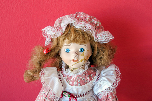 little old doll of the last century adjusted after breaking by fall or violent play