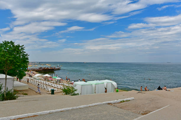 Ukraine, Odessa 07/28/2020. Otrada is a popular Odessa beach, people relax on the seashore and swim in the sea. The beach is clean and well-groomed, moderately crowded, and there are many cafes, clubs and restaurants within walking distance.