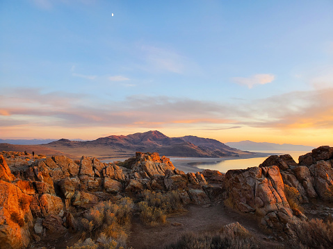 The sunset emits a warm glow across the surrounding rock at the Great Salt Lake.
