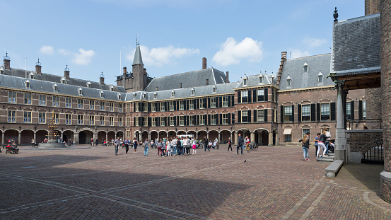 The Hague, South-Holland, The Netherlands, june 24th 2015, tourists and students on the Binnenhof courtyard, the 13th century complex is the centre of Dutch politics, a national heritage site ('rijksmonument') and holds the office of the Prime Minister ans is the meeting place for the States General of the Netherland