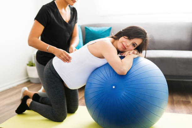 istock Pretty expectant mother smiling while receiving a massage 1304284822