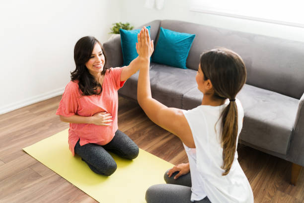 istock Doula and expectant mother preparing to do a workout 1304284841