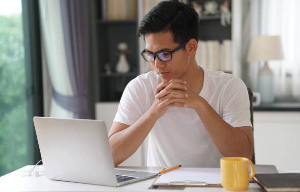 istock asian young student man entrepreneur working with computer studying learning online at home. e-learning webinar meeting. social distance in covid pandemic 1304287411