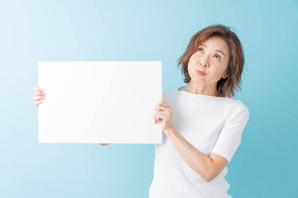 istock senior age woman having a white board, think, 1304291674