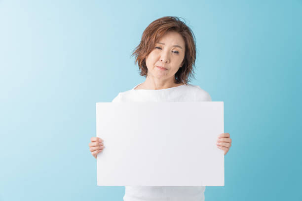 istock senior age woman having a white board, think, 1304291693