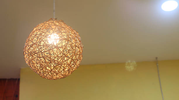 istock bulb lamps shining on yellow background 1304294273