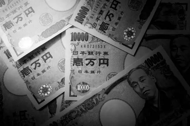 B&W of Japanese ten-thousand yen bills arranged randomly