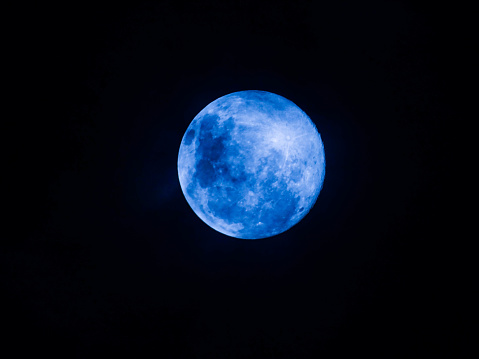 night view of the moon with blue sparkle