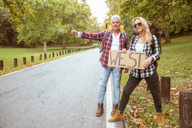 istock A middle-aged couple is hitchhiking 1304295117