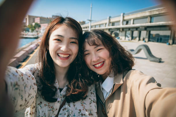 istock Two Asian women taking selfie in the park 1304295948
