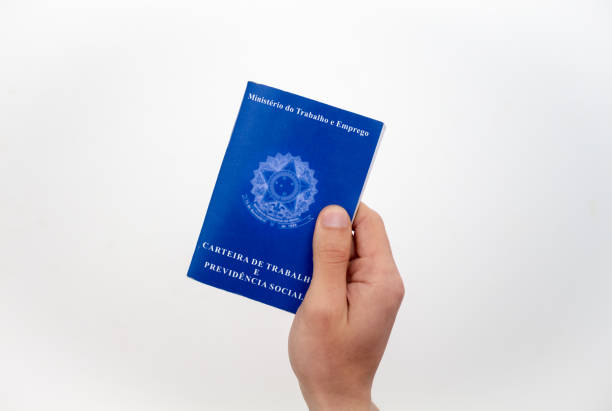 istock Hand holding Brazilian work card 1304297720