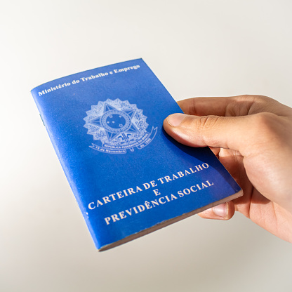 Person Holding a Brazilian Work Card in search of formal employment
