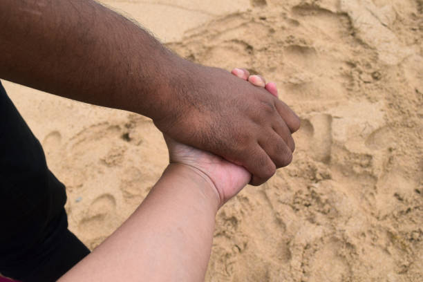 istock Holding hands with someone you love on the beach 1304299145
