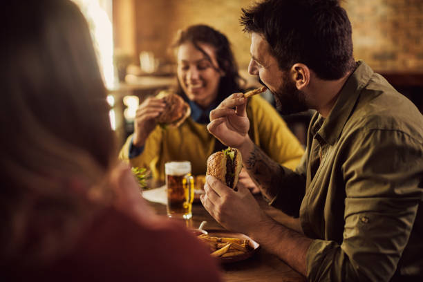 istock Group of friends enjoying while having lunch in a pub. 1304304501