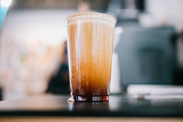 A close up shot of a cup of cold brew coffee with rising tiny nitrous oxide bubbles rising to the surface.  A cold refreshing caffeinated beverage on a hot day.
