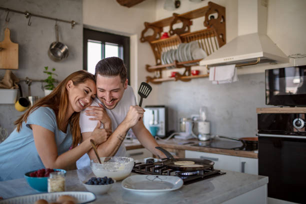 istock Young couple preparing breakfast in their kitchen 1304306630