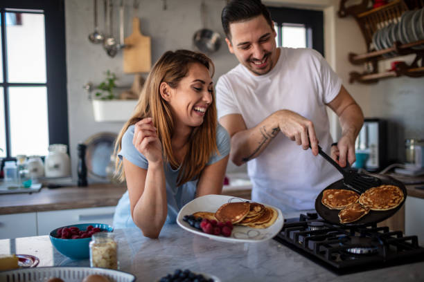 istock Young couple preparing breakfast in their kitchen 1304306670