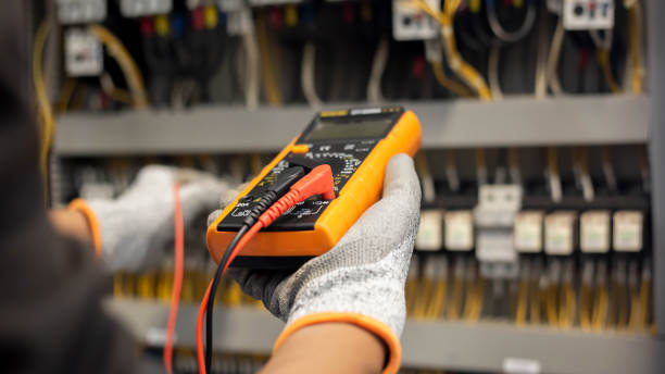 istock Electrician engineer uses a multimeter to test the electrical installation and power line current in an electrical system control cabinet. 1304306724