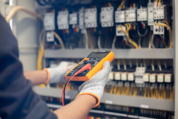 istock Electrician engineer uses a multimeter to test the electrical installation and power line current in an electrical system control cabinet. 1304306726