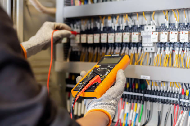 istock Electrician engineer uses a multimeter to test the electrical installation and power line current in an electrical system control cabinet. 1304306733