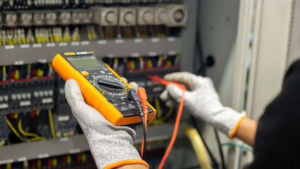istock Electrician engineer uses a multimeter to test the electrical installation and power line current in an electrical system control cabinet. 1304306735
