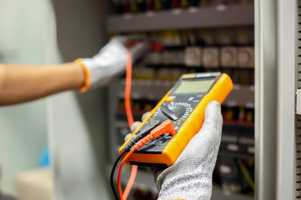istock Electrician engineer uses a multimeter to test the electrical installation and power line current in an electrical system control cabinet. 1304306742