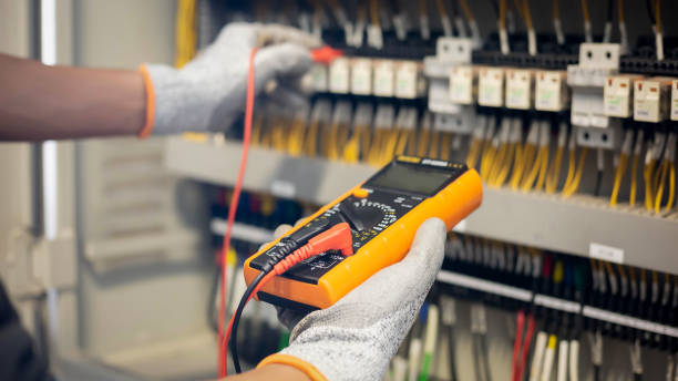 istock Electrician engineer uses a multimeter to test the electrical installation and power line current in an electrical system control cabinet. 1304306747