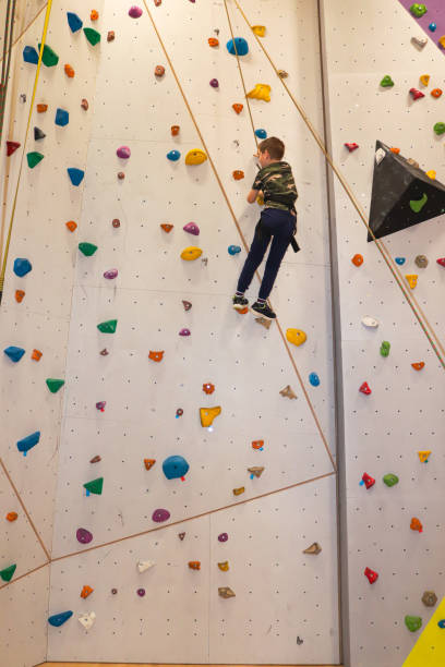 istock Young boy climbing with rope on climbing wall 1304311238