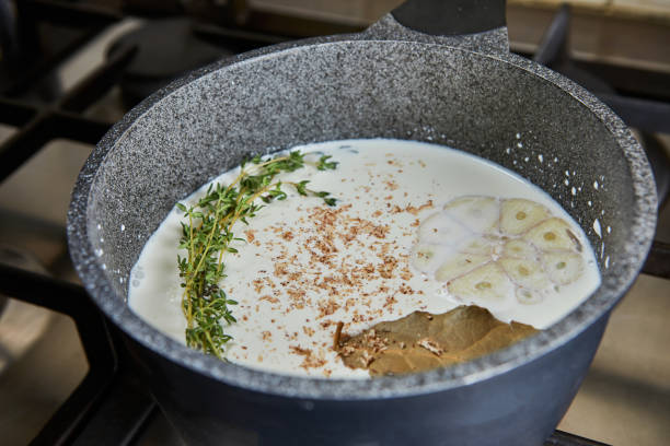 istock Sauce in a saucepan made from cream, garlic, bay leaf and nuts 1304313456
