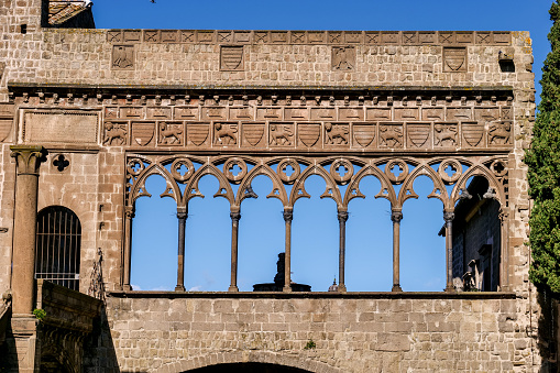 Viterbo, Italy, February 11 -- The pointed arches of the Loggia of the Palace of the Popes (Palazzo dei Papi) in the square of the Cathedral of Saint Lawrence (San Lorenzo), the main church of Viterbo, the capital of the ancient Tuscia region. This suggestive medieval town stands on the route of the ancient Via Francigena which in medieval times connected the regions of France to Rome up to the commercial ports of Puglia to reach the Holy Land. Image in High Definition format.