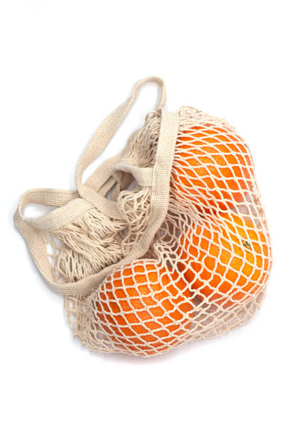 istock Oranges in a beige natural cotton string bag 1304315310