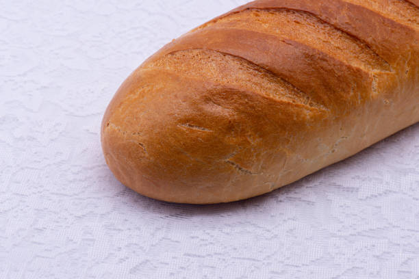 istock Loaf of bread on a white tablecloth 1304316086